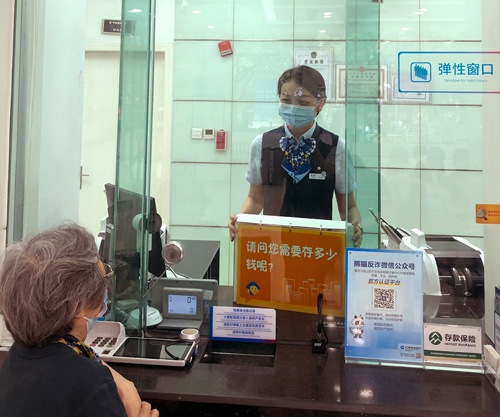 建行成都金河支行，柜面員工使用“關(guān)愛(ài)服務(wù)卡”服務(wù)老年客戶